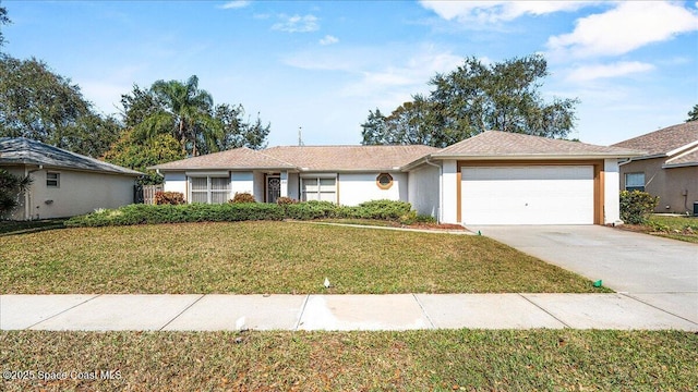 single story home with an attached garage, a front lawn, concrete driveway, and stucco siding