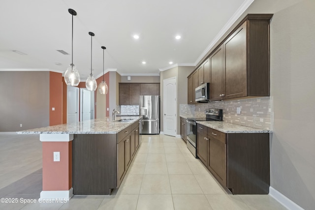 kitchen featuring sink, light stone counters, hanging light fixtures, an island with sink, and stainless steel appliances