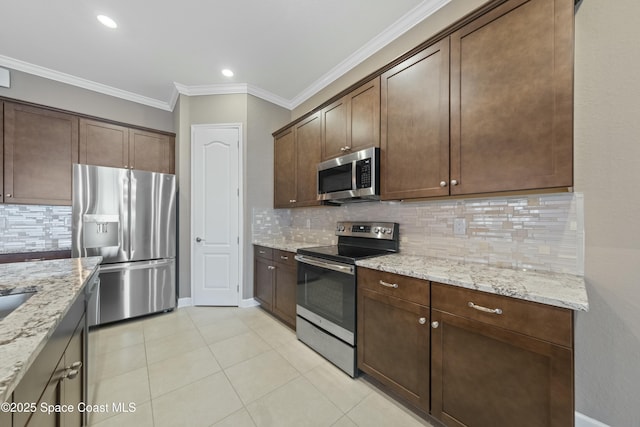 kitchen with light stone counters, crown molding, dark brown cabinets, appliances with stainless steel finishes, and backsplash