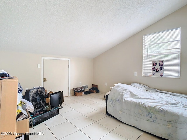 tiled bedroom with vaulted ceiling and a textured ceiling