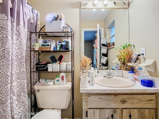 bathroom featuring vanity and toilet