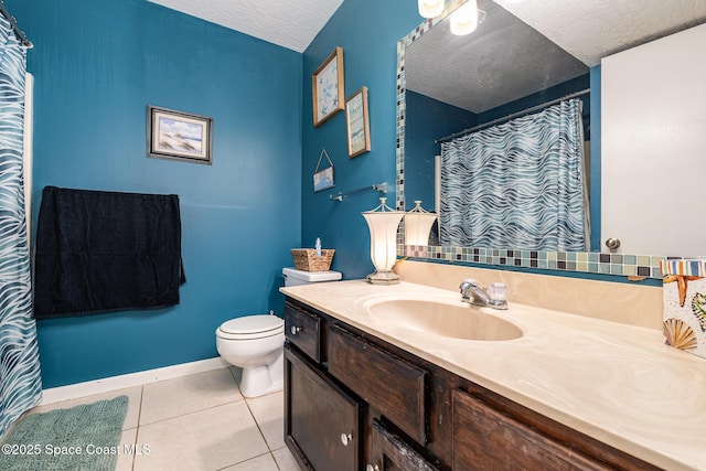 bathroom featuring tile patterned floors, toilet, a textured ceiling, and vanity