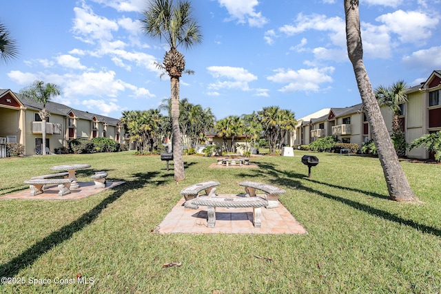 view of community featuring a yard and a patio