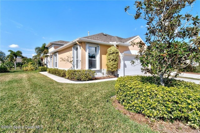 view of front of property with a garage and a front yard