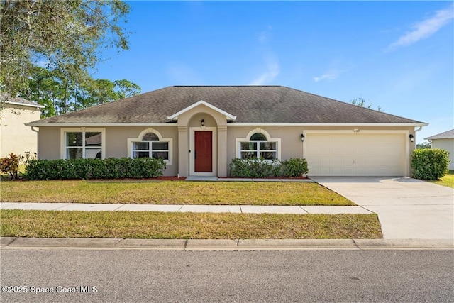 ranch-style home with a garage and a front yard