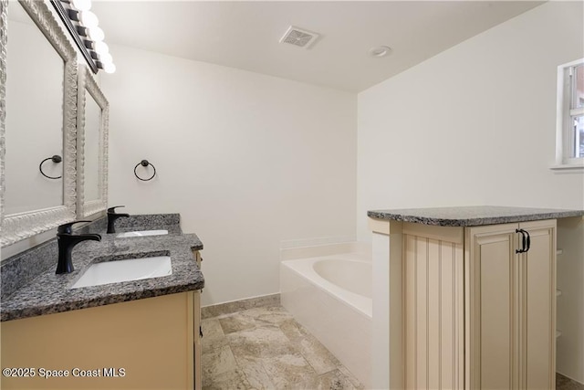 bathroom with vanity and a bathtub