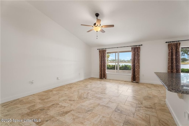 spare room with vaulted ceiling and ceiling fan