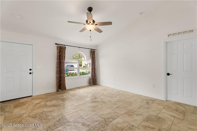 spare room featuring vaulted ceiling and ceiling fan