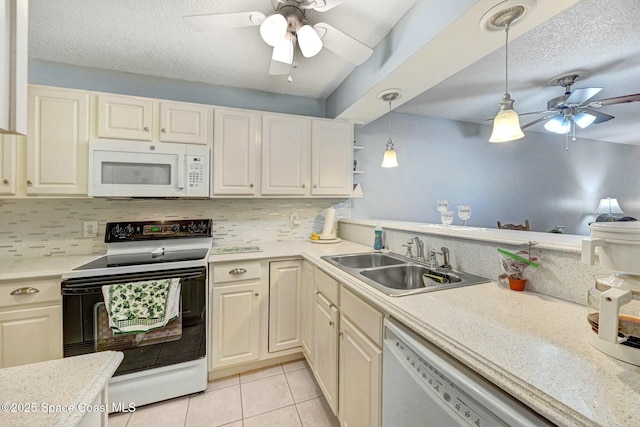 kitchen with sink, white appliances, a textured ceiling, light tile patterned flooring, and decorative light fixtures