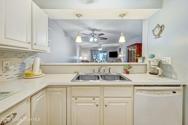 kitchen with sink, dishwasher, hanging light fixtures, backsplash, and a textured ceiling