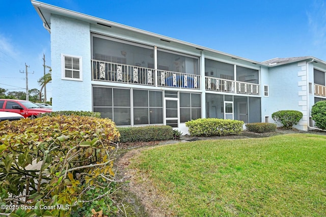 rear view of house with a yard