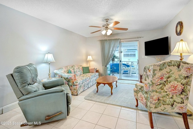 tiled living room featuring ceiling fan and a textured ceiling