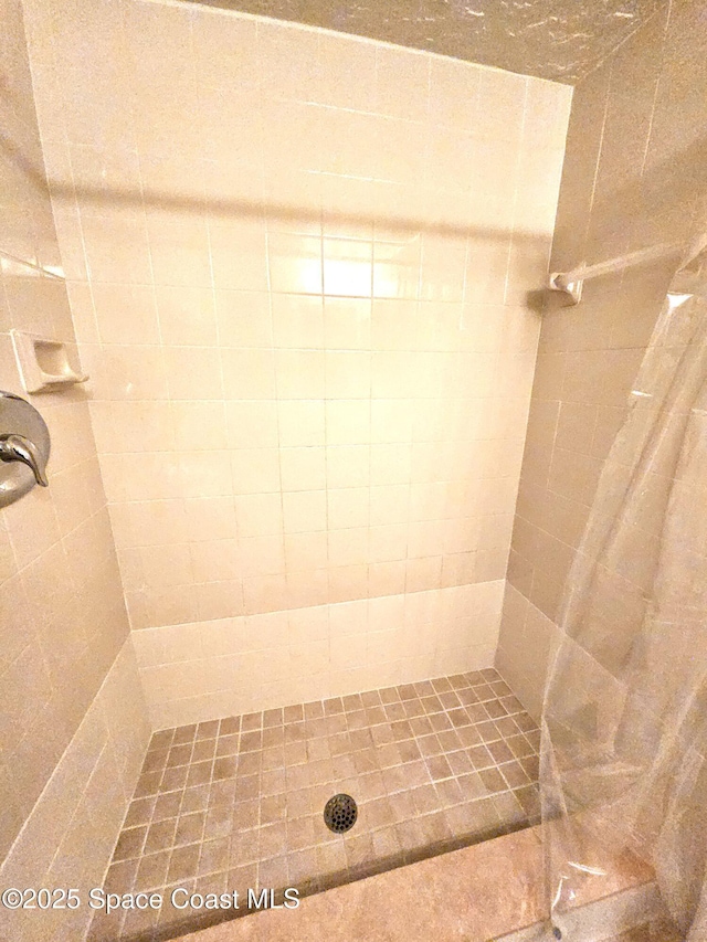 bathroom with tiled shower