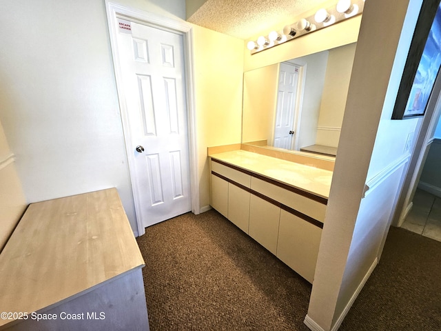 bathroom featuring vanity and a textured ceiling