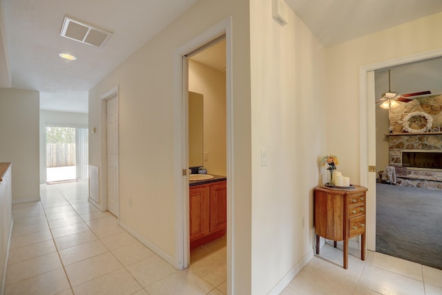 hall with light tile patterned floors and sink