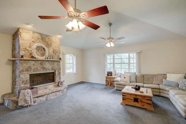 living room featuring vaulted ceiling, carpet, and a fireplace