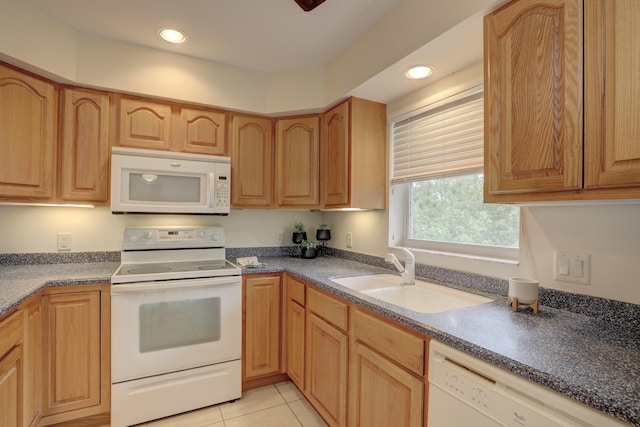 kitchen with light tile patterned flooring, white appliances, and sink