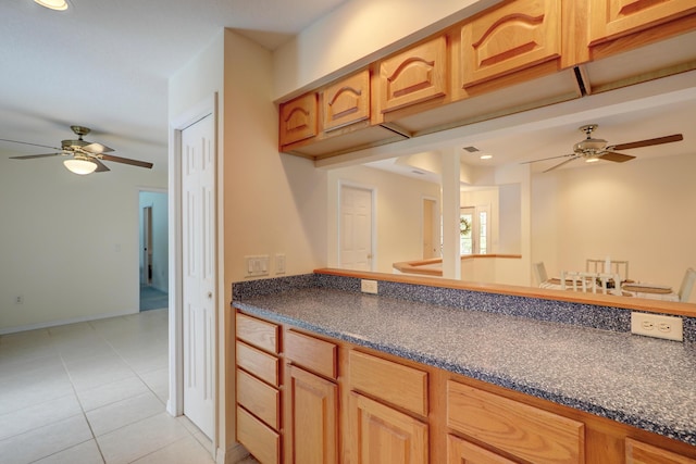 kitchen with light tile patterned flooring and ceiling fan