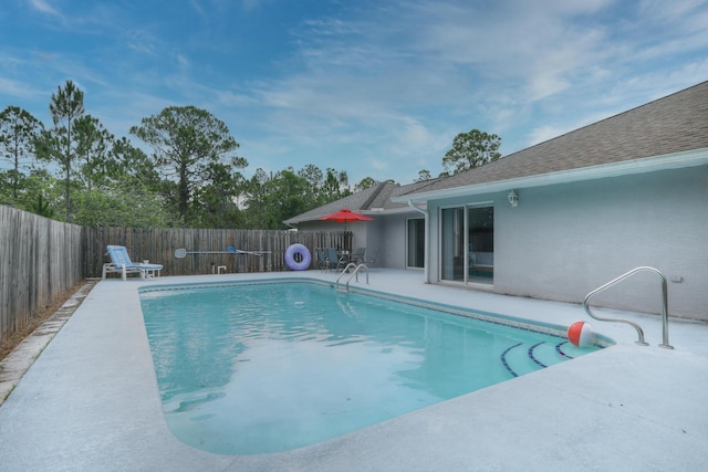 view of swimming pool featuring a patio area