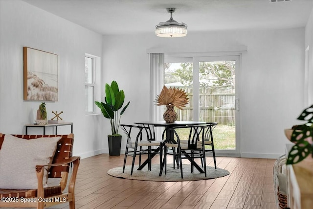 dining space with light wood-type flooring