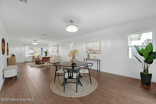 dining area featuring dark wood-type flooring