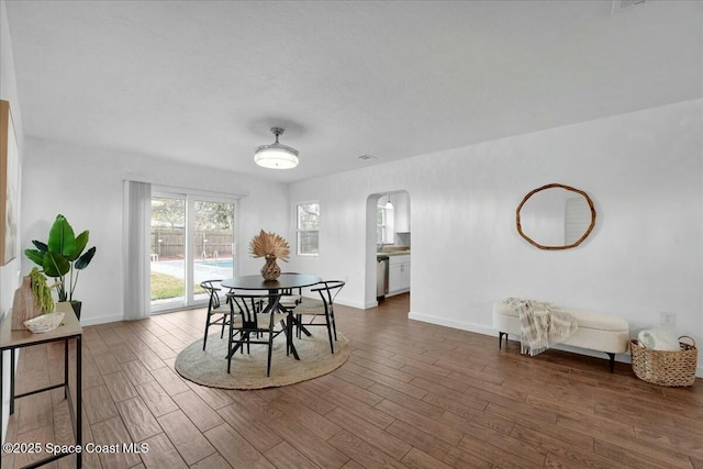 dining area featuring dark wood-type flooring