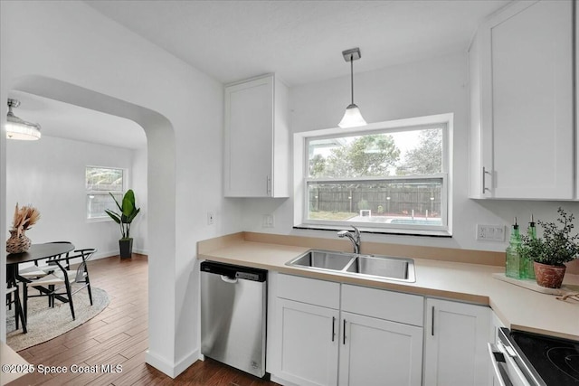 kitchen with stainless steel appliances, white cabinetry, and sink