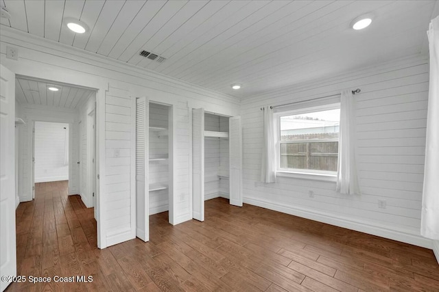 unfurnished bedroom featuring wooden ceiling, wood-type flooring, and wood walls