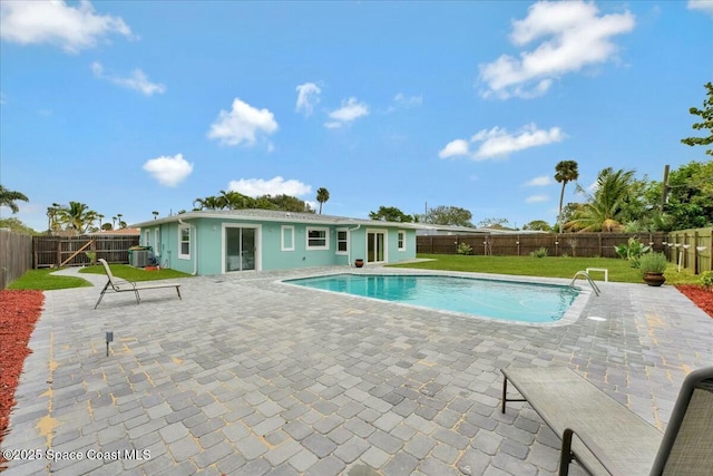 view of pool featuring a lawn, a patio, and central air condition unit