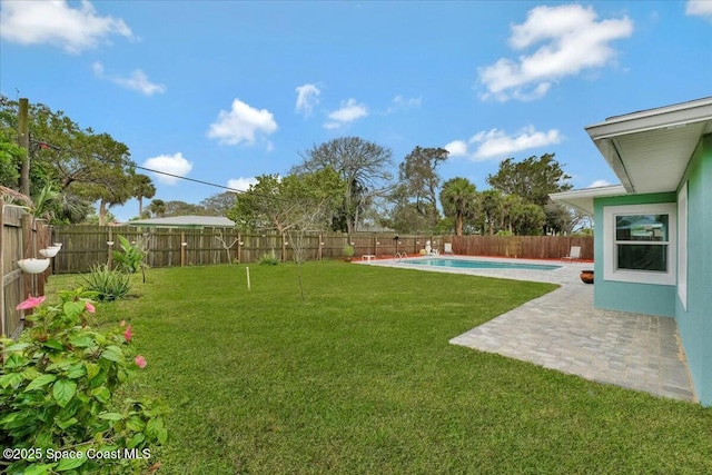 view of yard featuring a fenced in pool and a patio