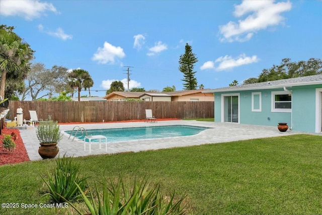 view of swimming pool with a yard and a patio area