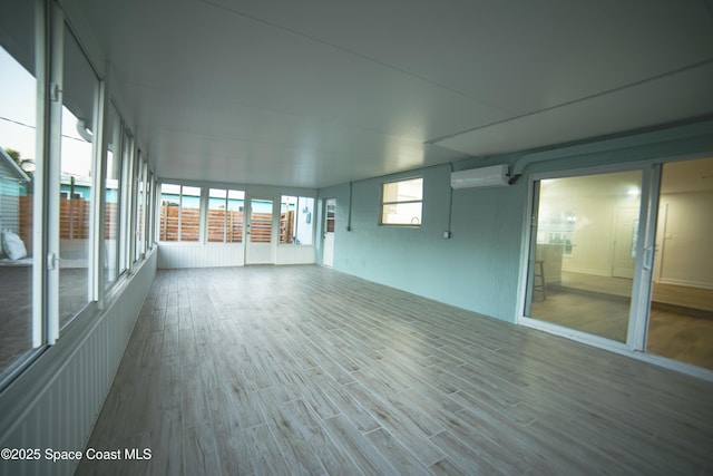 unfurnished sunroom featuring a wall mounted air conditioner