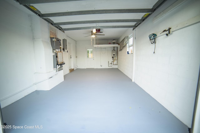 garage featuring heating unit, a garage door opener, and electric panel