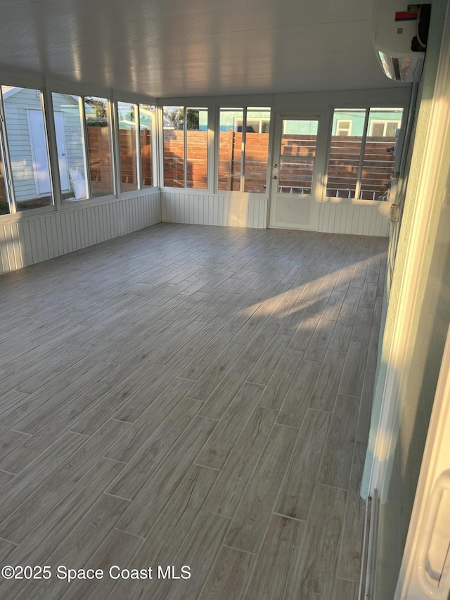 unfurnished sunroom featuring plenty of natural light