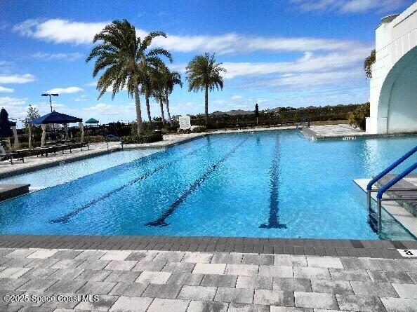 community pool with a patio area