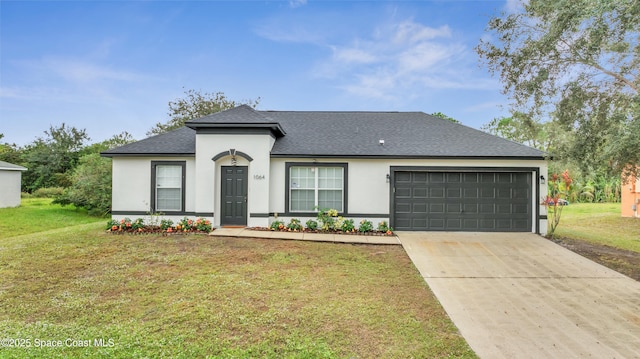 single story home featuring a garage and a front lawn