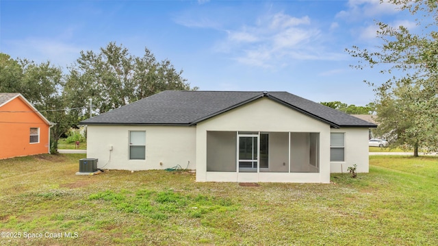 rear view of property featuring a sunroom, a yard, and cooling unit