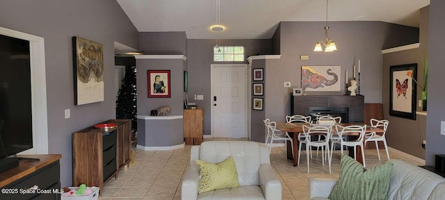 interior space featuring lofted ceiling, a notable chandelier, and a fireplace