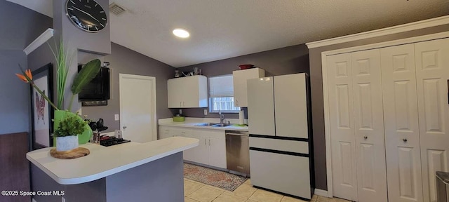 kitchen featuring sink, white cabinets, white fridge, stainless steel dishwasher, and a textured ceiling