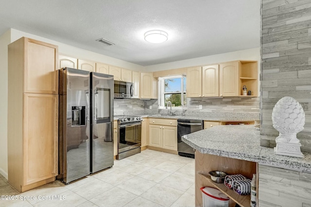 kitchen with tasteful backsplash, stainless steel appliances, sink, and light brown cabinets