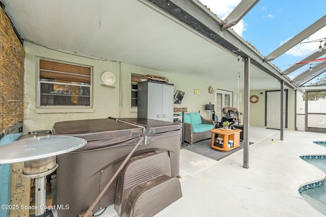 view of patio with a swimming pool with hot tub and a lanai