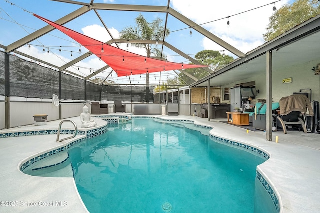 view of pool featuring a lanai, a patio, and an in ground hot tub