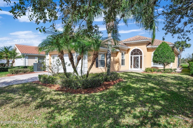 mediterranean / spanish home with a front lawn and central air condition unit