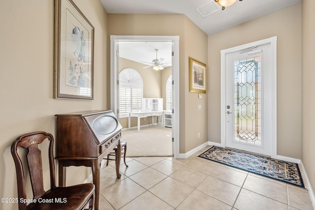 entrance foyer featuring light tile patterned floors and ceiling fan