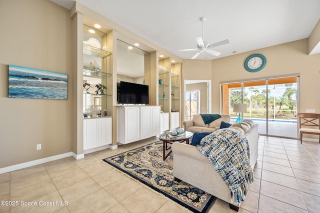 living room with light tile patterned flooring, a textured ceiling, ceiling fan, and built in shelves