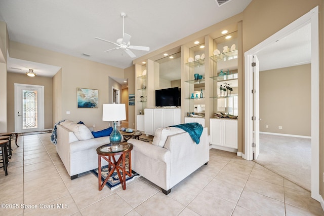 living room with light tile patterned floors and ceiling fan