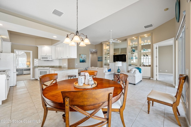 dining area with ceiling fan with notable chandelier and light tile patterned flooring