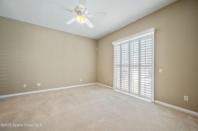 carpeted empty room with a textured ceiling and ceiling fan