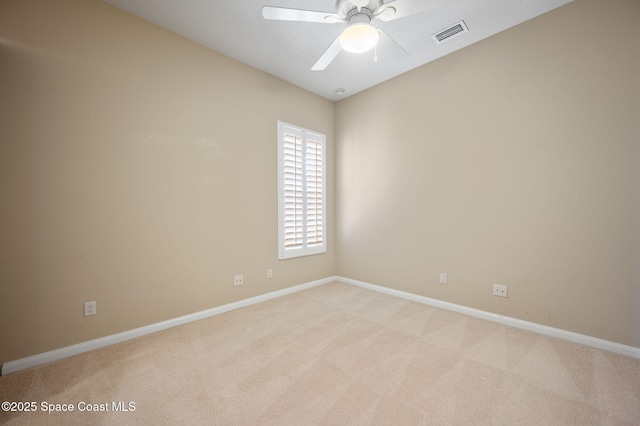 empty room with ceiling fan and light carpet