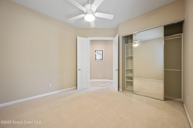 unfurnished bedroom with ceiling fan, light colored carpet, and a closet